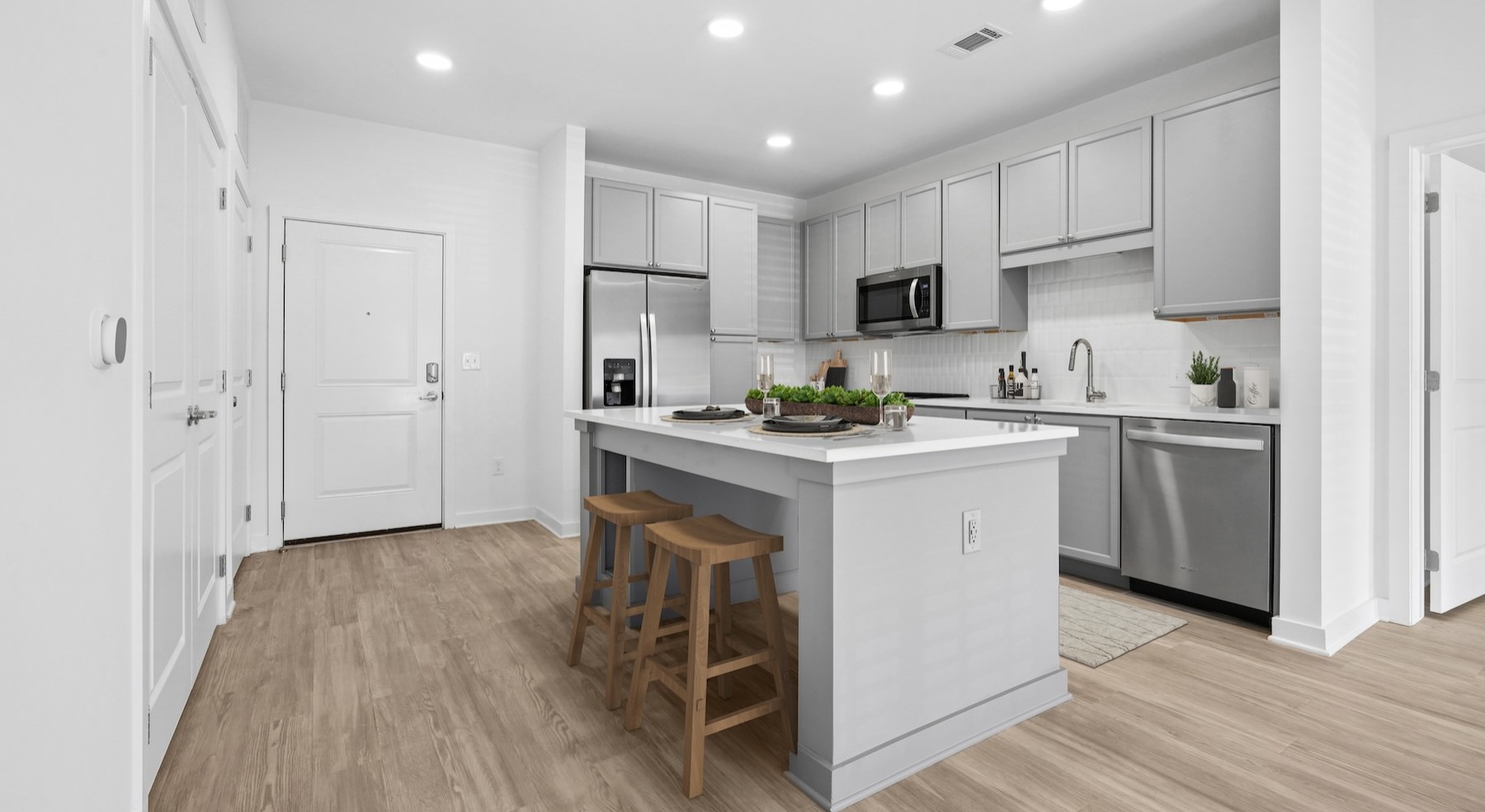 a kitchen with grey cabinets