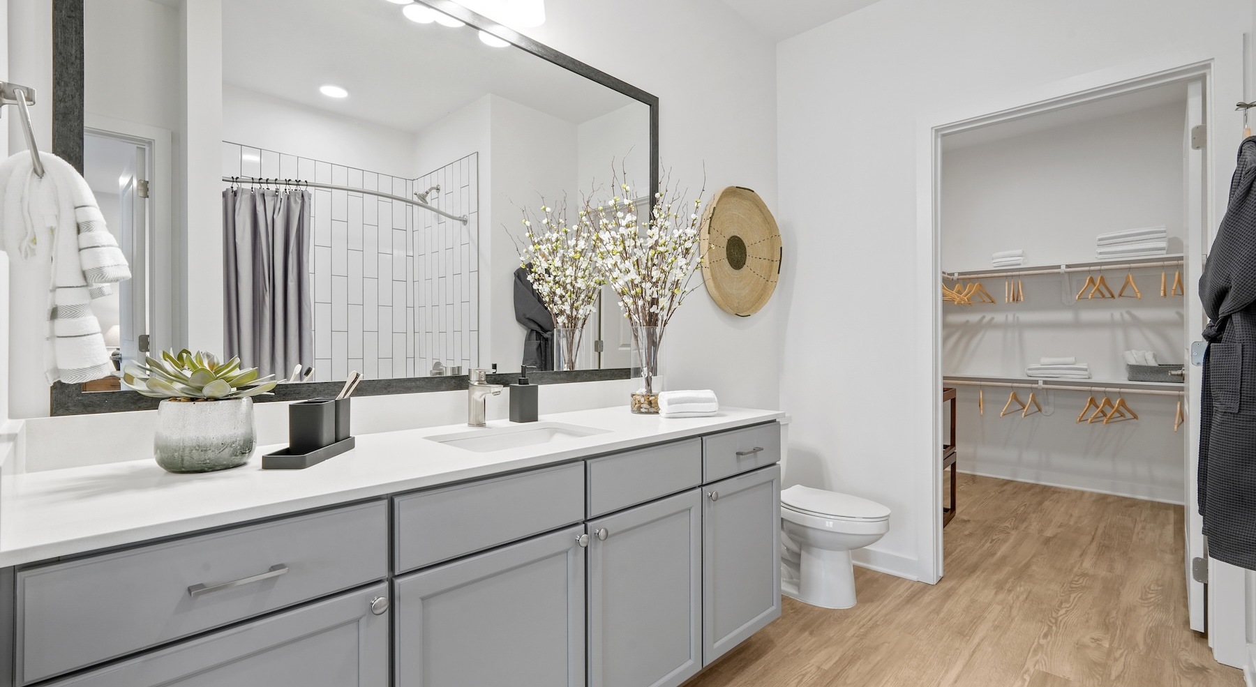 a bathroom with a sink, toilet and mirror